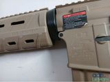 the lower part of a tan ar - 15 rifle with a red dot on the side