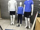 three mannequins are lined up in a room with a blue mat