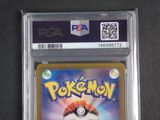 the pokemon card is in a clear plastic holder on a table
