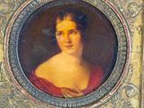 portrait of a woman in a red dress in a silver frame