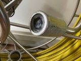 a close up view of a bicycle wheel with a yellow hose
