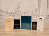 three boxes of perfume sitting on top of a table next to each other