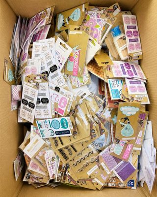 a cardboard box filled with lots of stickers and stickers