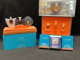 two small boxes with perfumes in them sitting on a table