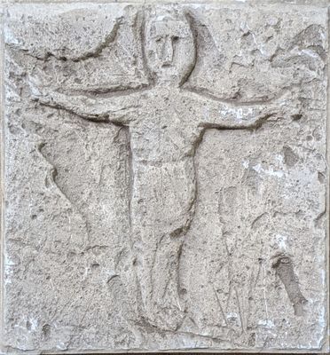 an image of a stone relief of a man on a cross