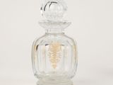 an image of a glass bottle with a gold design on it