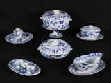 six pieces of blue and white china on a black background