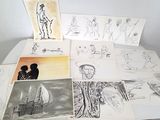 une table sur laquelle sont posés plusieurs dessins