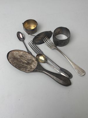 a lot of silver spoons and spoons on the table
