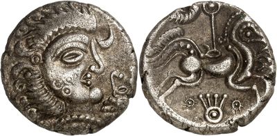 a silver coin with an image of a woman and a dragon on it