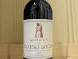 a bottle of red wine sitting on a wooden shelf