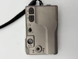 a silver camera with a black cord attached to it