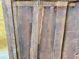 an old wooden cabinet with a door on it