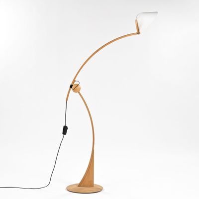 a wooden floor lamp with a white light on top of it