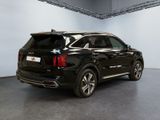 the rear end of a black suv parked in a garage