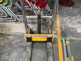 a fork lifter that is sitting in the middle of a room