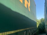 two trucks that are parked next to each other on the side of the road