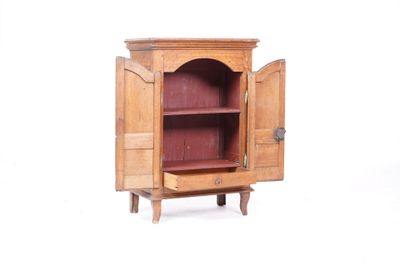 a wooden cabinet with a door open on a white background