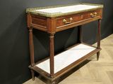 a wooden table with a marble top on a wooden floor