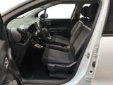 the interior of a car with the door open and the driver ' s seat down