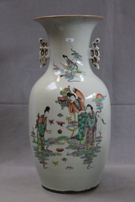 a vase with a painting on it sitting on a table