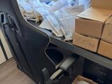 a desk with a chair and boxes of boxes on it