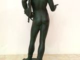 bronze statue of a man holding a gun on a pedestal