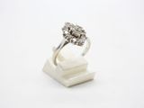 a close up of a diamond ring on a white surface