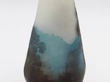 a blue and white vase sitting on a white surface