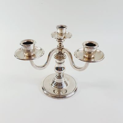silver plated candelab with three candles on each side