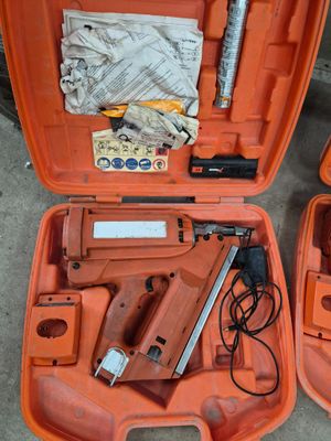 two orange tools in a case on the ground
