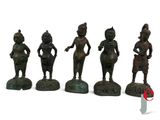 five bronze figurines of women in different poses on a white surface