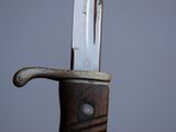 a close up of a knife with a handle on it