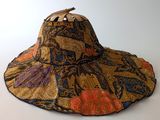 a close up of a hat on a table with a white background