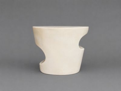 a white vase that is sitting on a table