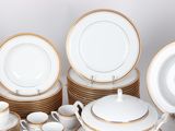 many plates and cups and saucers on the table