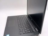 a laptop computer sitting on a white surface