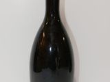 bottles of wine are lined up on a white surface