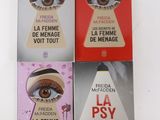 three books on a white table with a picture of a woman ' s eye and a man ' s eye