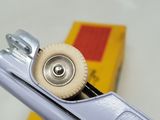 a close up of a metal object with a yellow box in the background