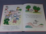 an open book with a picture of an elephant and other animals