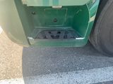 a close up of the front bumper of a green truck