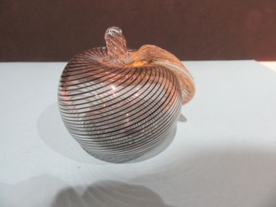 a glass apple that is sitting on a table