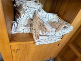 a wooden cabinet with a blanket on top of it