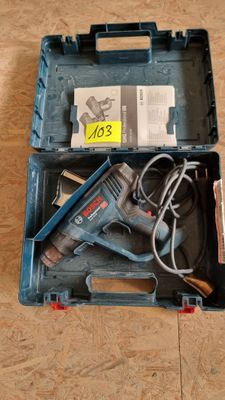 a tool box with a corded drill and other tools in it