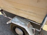 a boat that is sitting on a trailer on the street