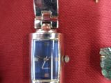 an image of a watch sitting on top of a red cloth