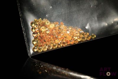 an image of a bag of gold colored crystals