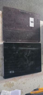 two laptops sitting on a counter next to each other