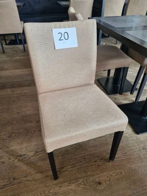 beige upholstered dining chair with a price tag on the back